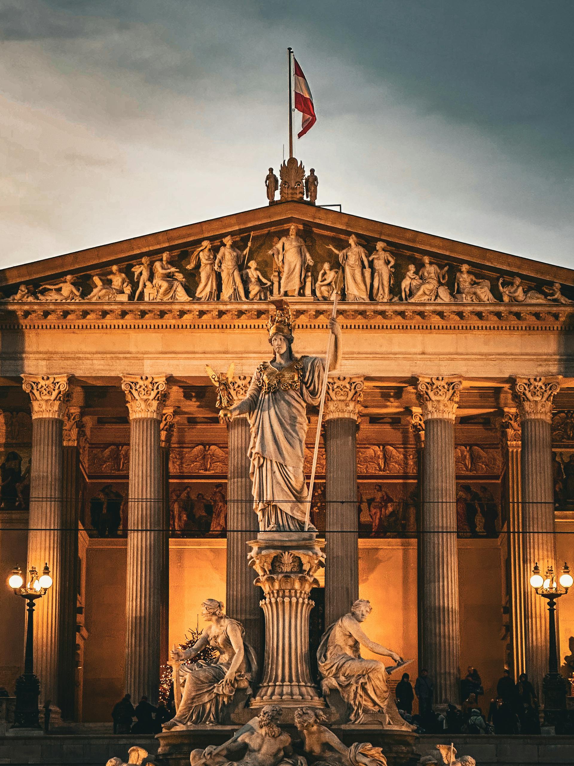 The beautiful building of the Austrian Parliament with the sculpture of Athena in front of it.