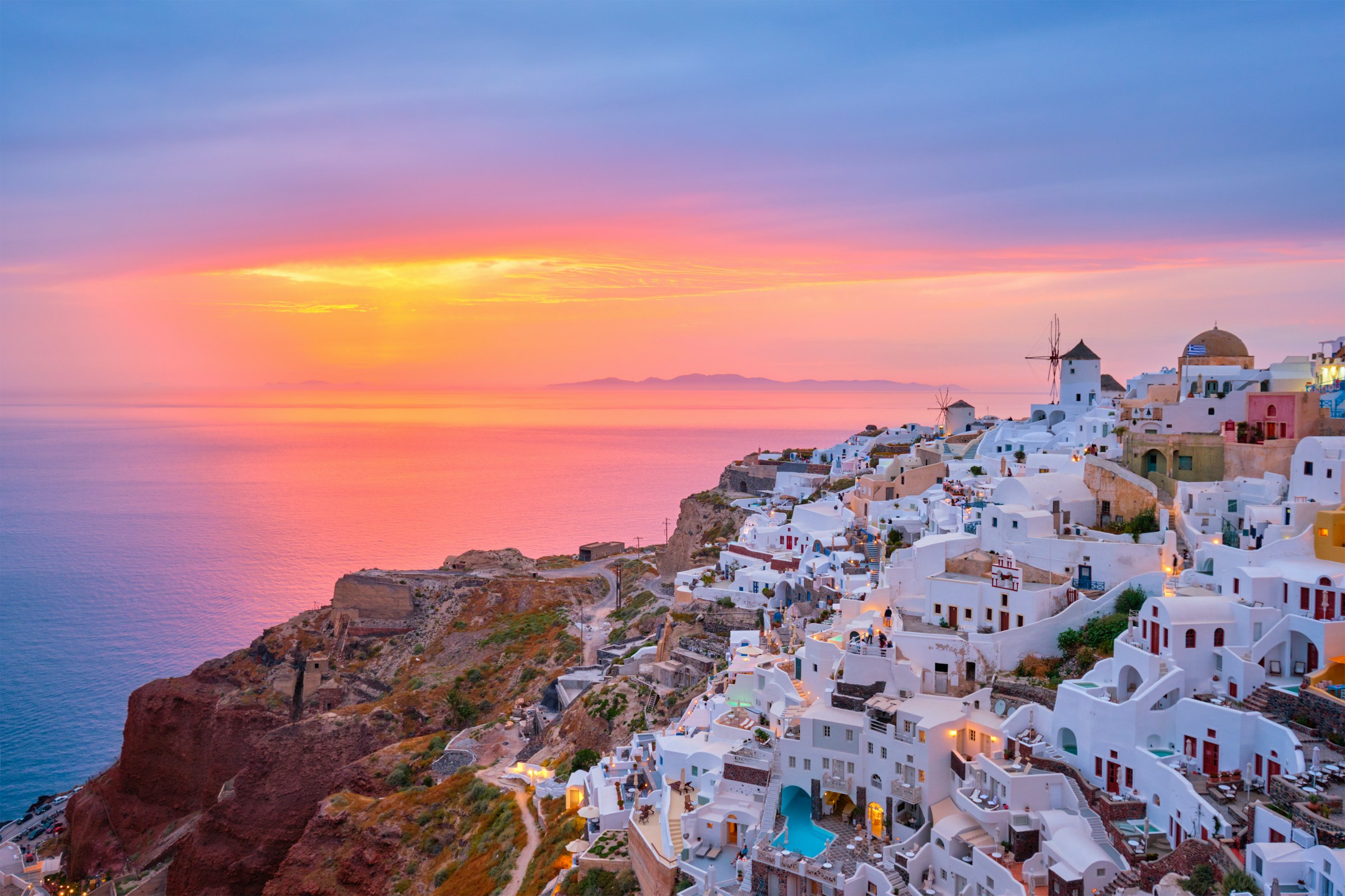 Santorini at sunset - one of the most popular tourist islands in the world suffers from overcrowding in the peak of summer.