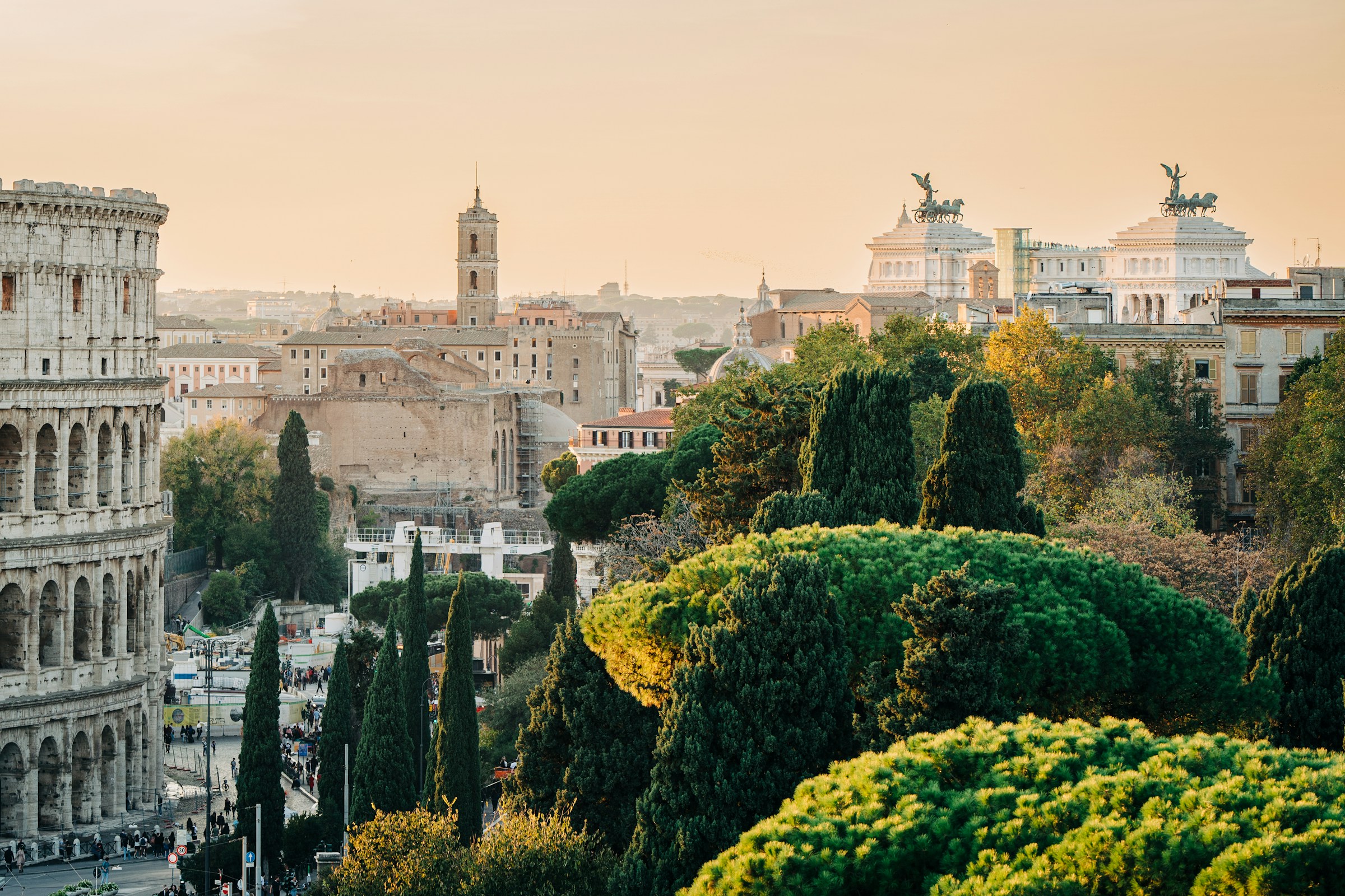 Roma, Italy - old historical buildings, and evergreen trees during golden hour.