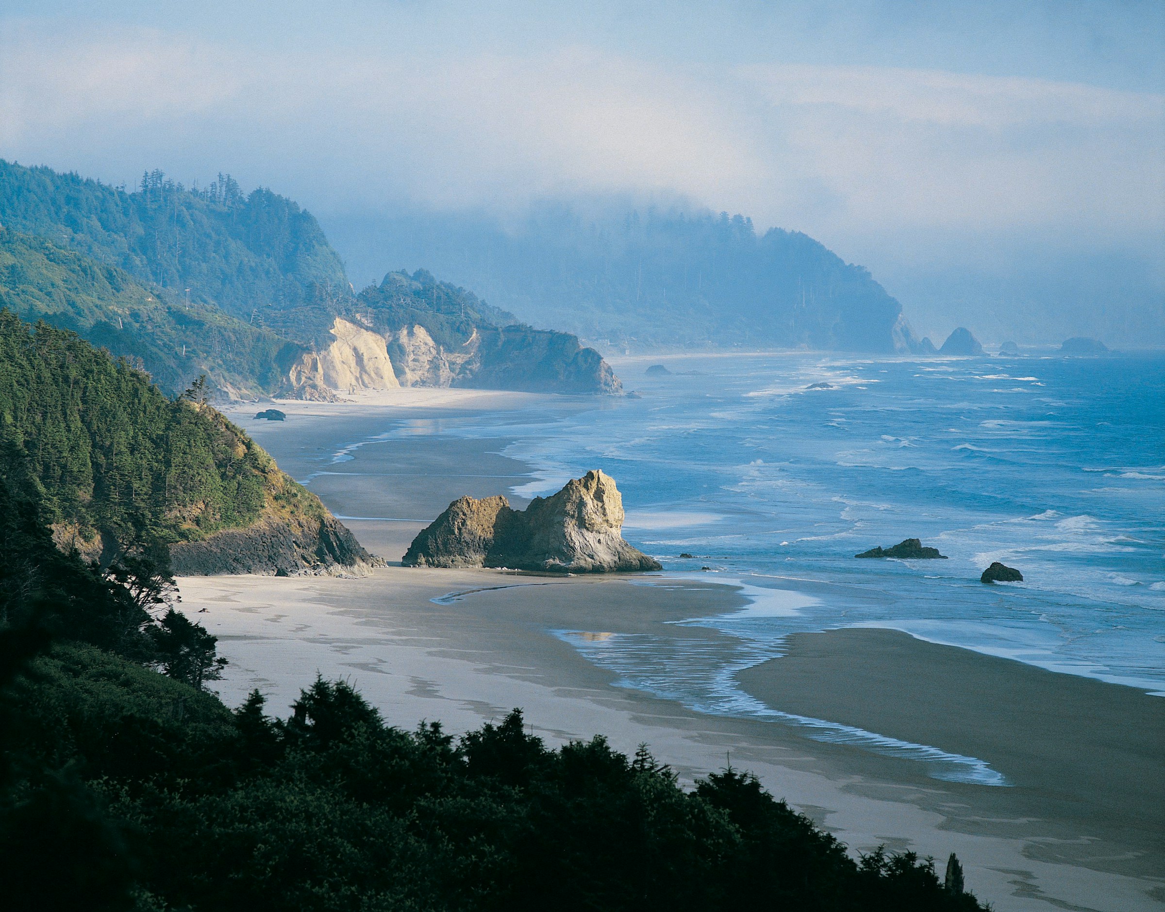 The Oregon coast draws photographers, not sunbathers - and that distinction matters, because the danger here isn't about swimming.