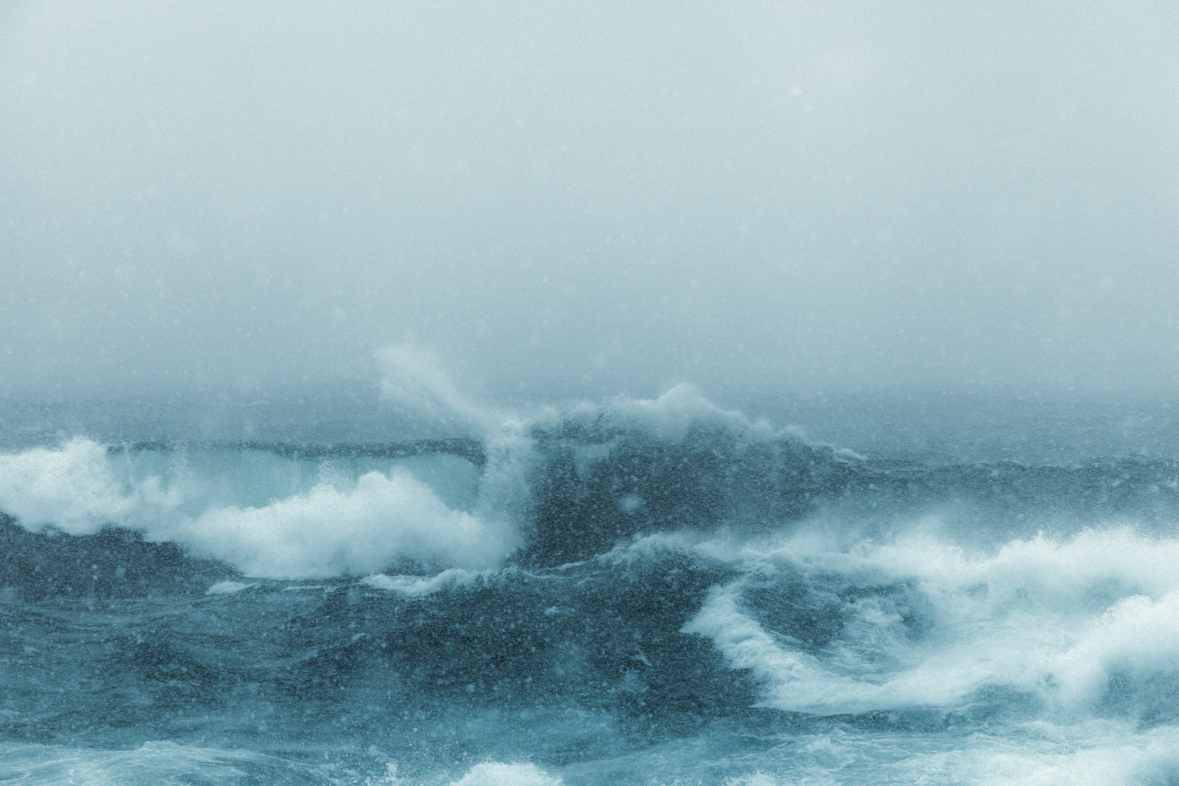 Violent winter sea - big waves crash into the shallows.