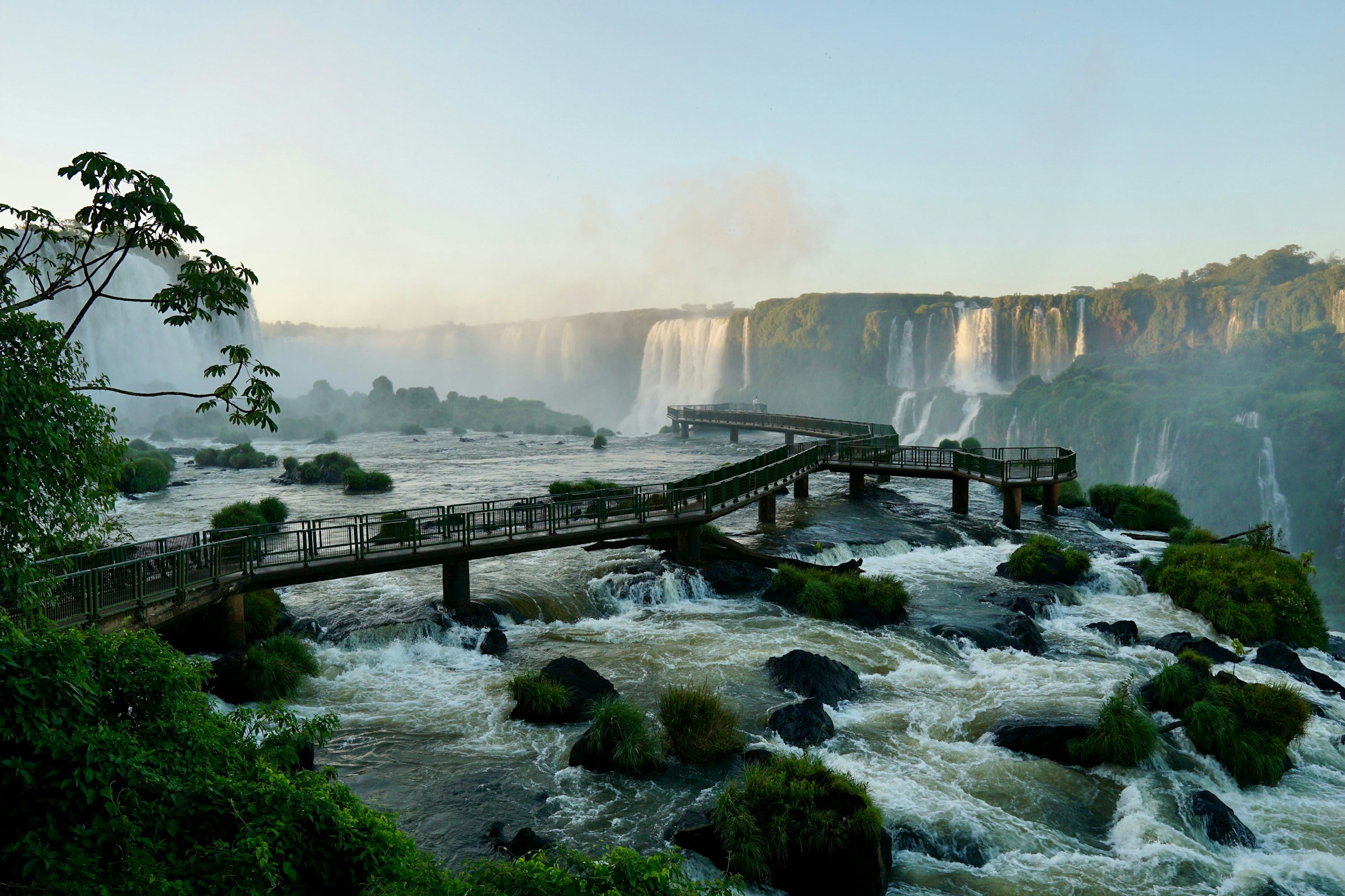 As seen in the image, the Devil's Throat Walkway offers visitors a unique chance to experience the magic of the waterfall up close during calm conditions. However, recent unusual flooding has temporarily forced the dismantling of the platform to prevent damage from the rising waters.